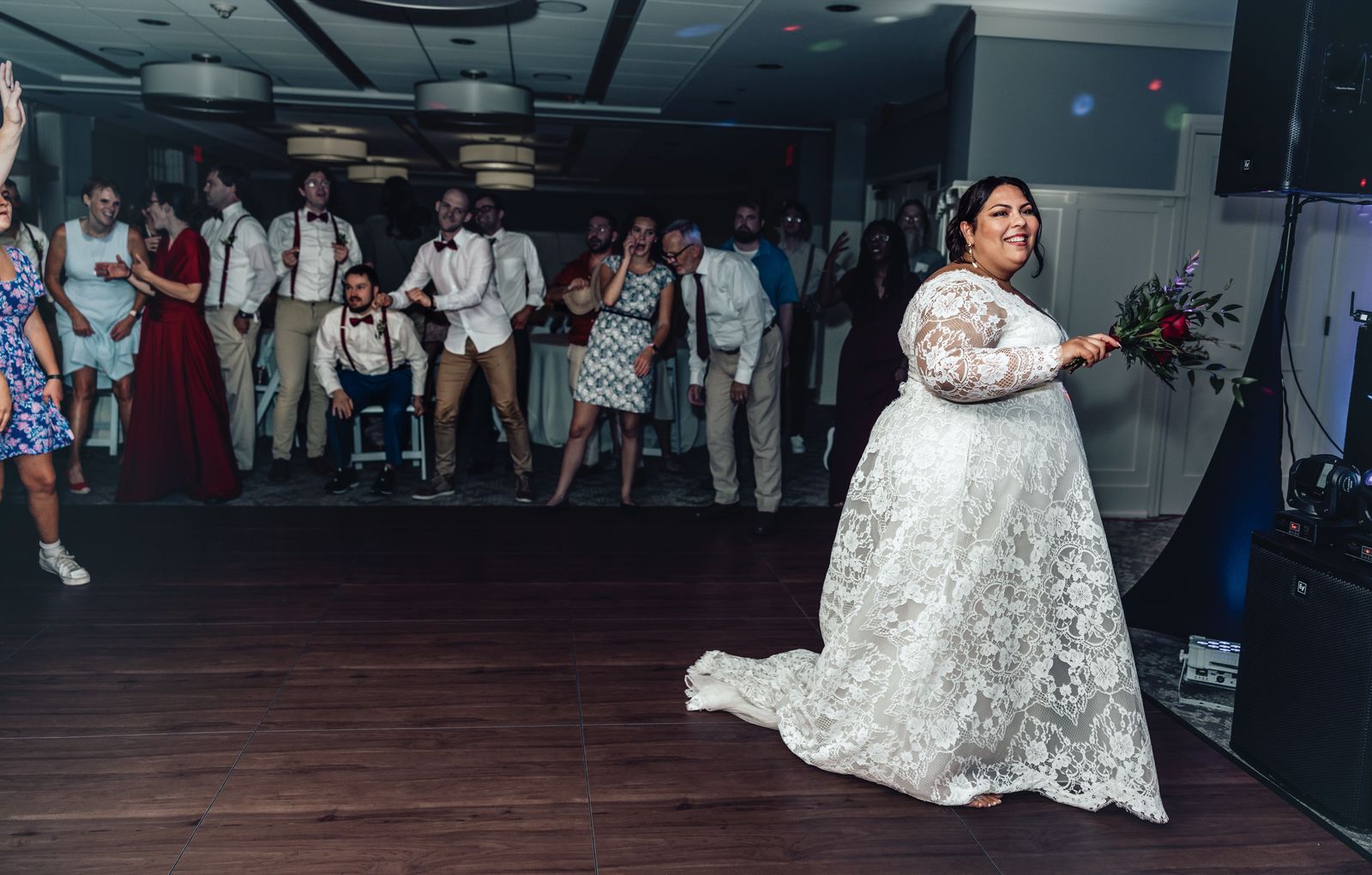 Bride dancing on the dance floor as guests watch