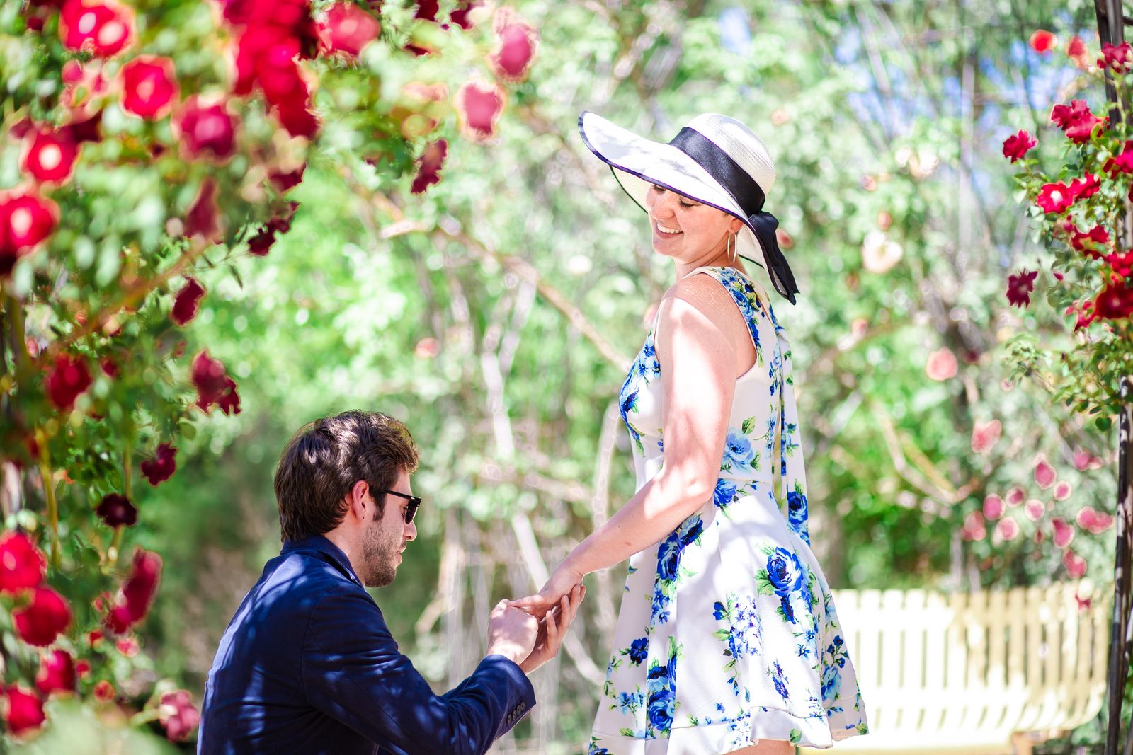 Closer view of the proposal as the woman in a sun hat smiles down